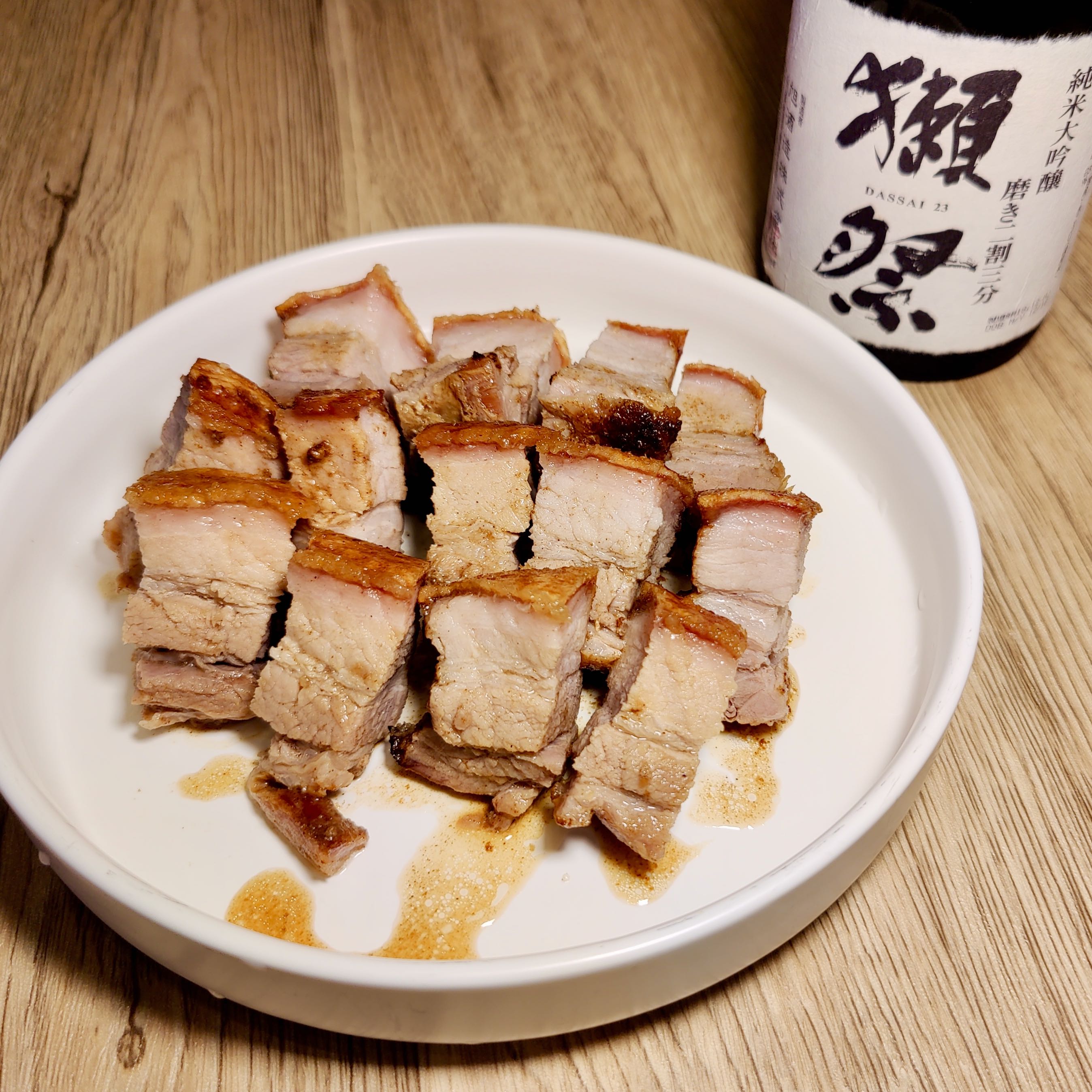 crispy pork belly with a side of sake